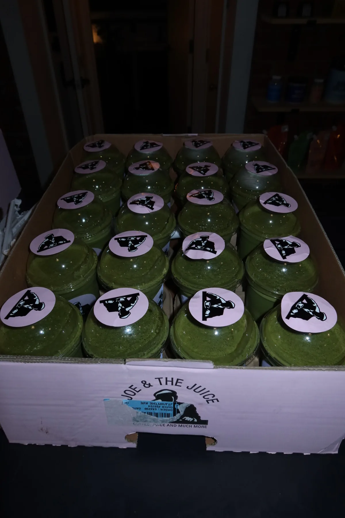 A box filled with green smoothies from Joe & The Juice, prepared for guests at the Storytime Wellness Reset Event at Kove Studio. The refreshing drinks complement the recovery-focused wellness experience.
