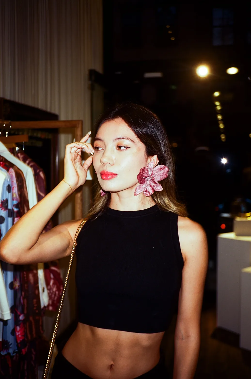 Guest wearing oversized pink floral statement earrings at the Colombiamoda Oficial x Storytime fashion event in NYC.