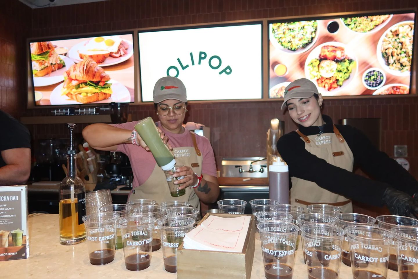 Carrot Express staff prepare and serve matcha drinks during the Storytime celebration for the grand opening of the new NoLita location in NYC.