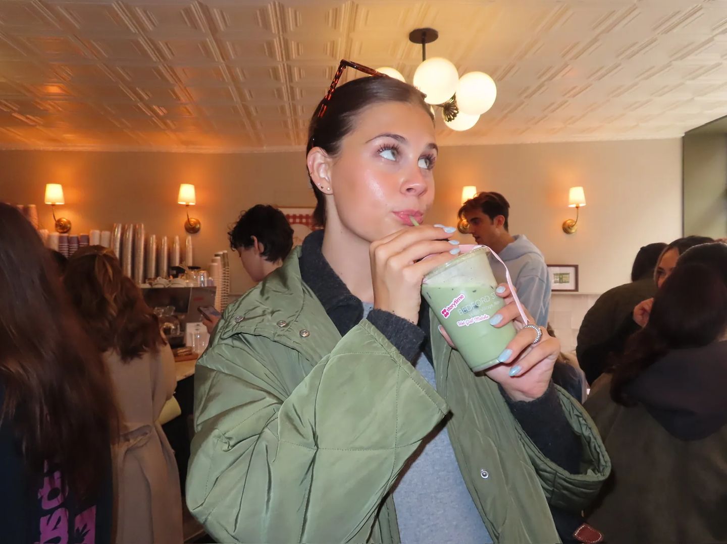A guest enjoys a signature Hot Girl Matcha drink during the Storytime x Bedford Studios NYC collaboration event in the West Village.