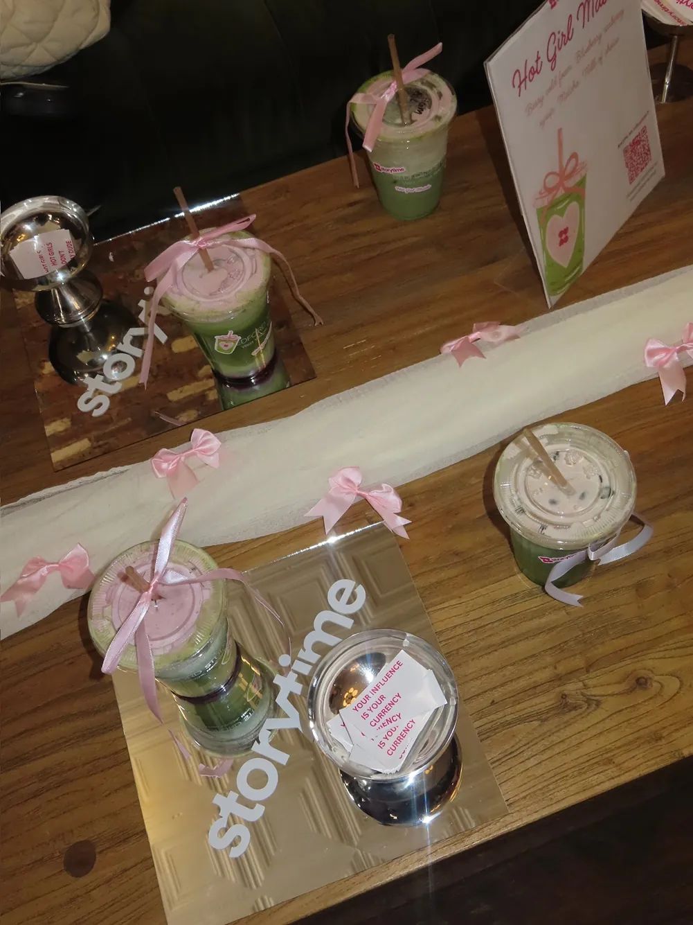 Signature Hot Girl Matcha drinks, pink ribbon décor, and Storytime branding are displayed during the Bedford Studios NYC collaboration event in the West Village.