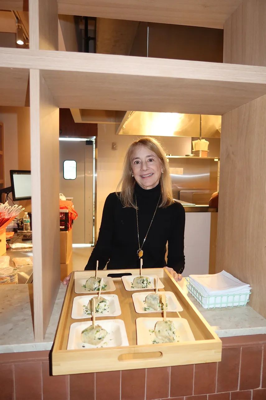 A guest presents a tray of bites during the Storytime celebration at the grand opening of the new Carrot Express NoLita location in NYC.