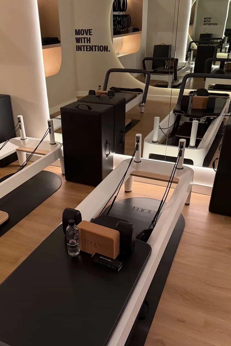 Modern reformer machines inside Mouv Pilates Studio prepared for a Storytime wellness event with Joe & The Juice in NYC.