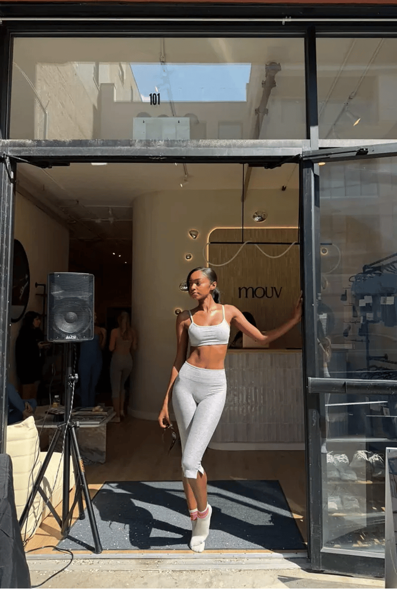 Guest arriving at Mouv Pilates Studio in NYC during the Storytime wellness event hosted with Joe & The Juice featuring pilates, community, and wellness experiences.