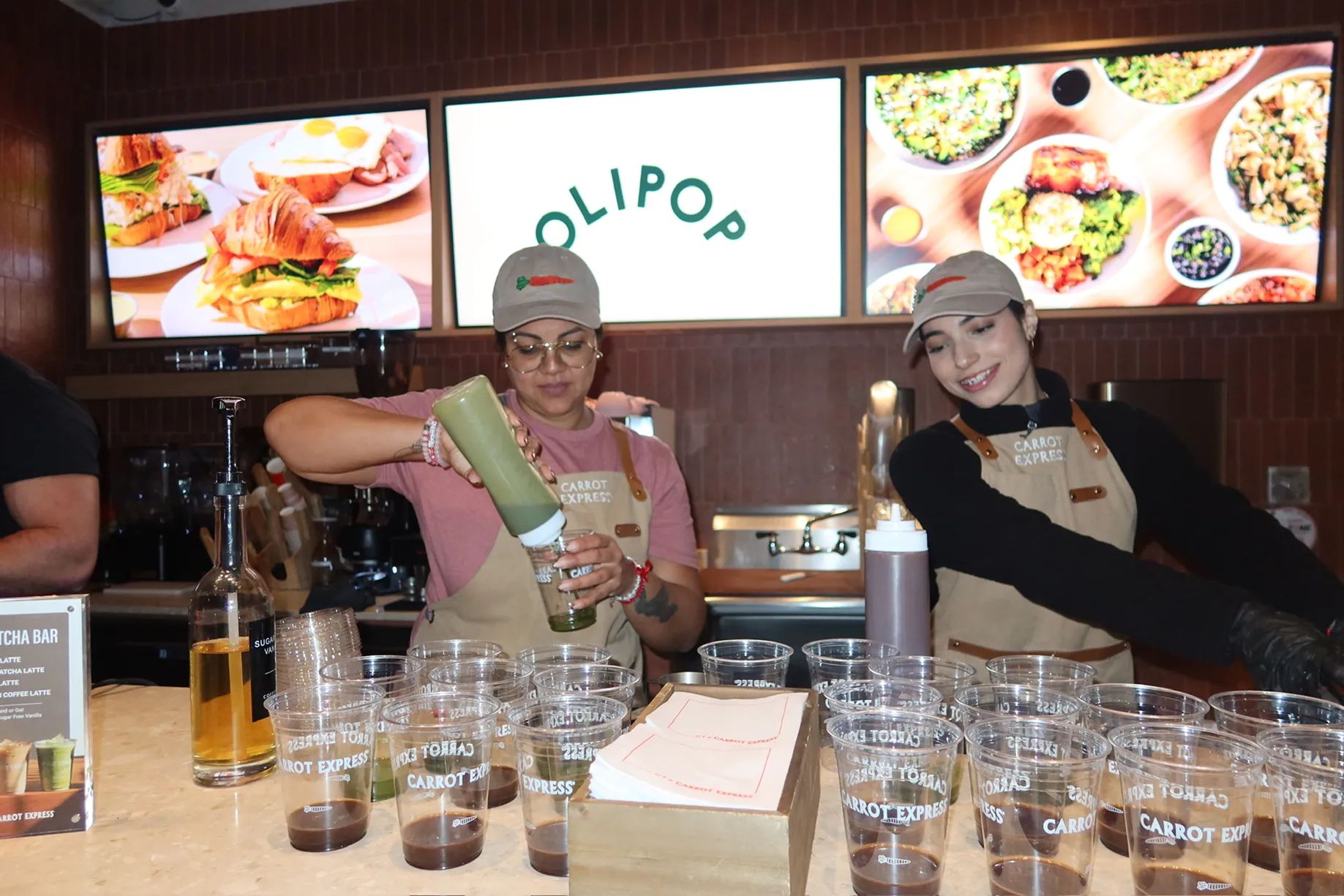 Carrot Express staff prepare and serve matcha drinks during the Storytime celebration for the grand opening of the new NoLita location in NYC.