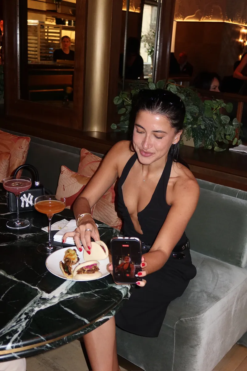 Storytime creator enjoying signature Beefbar sliders and cocktails while filming content during Beefbar NYC’s 2-year anniversary casino night celebration.